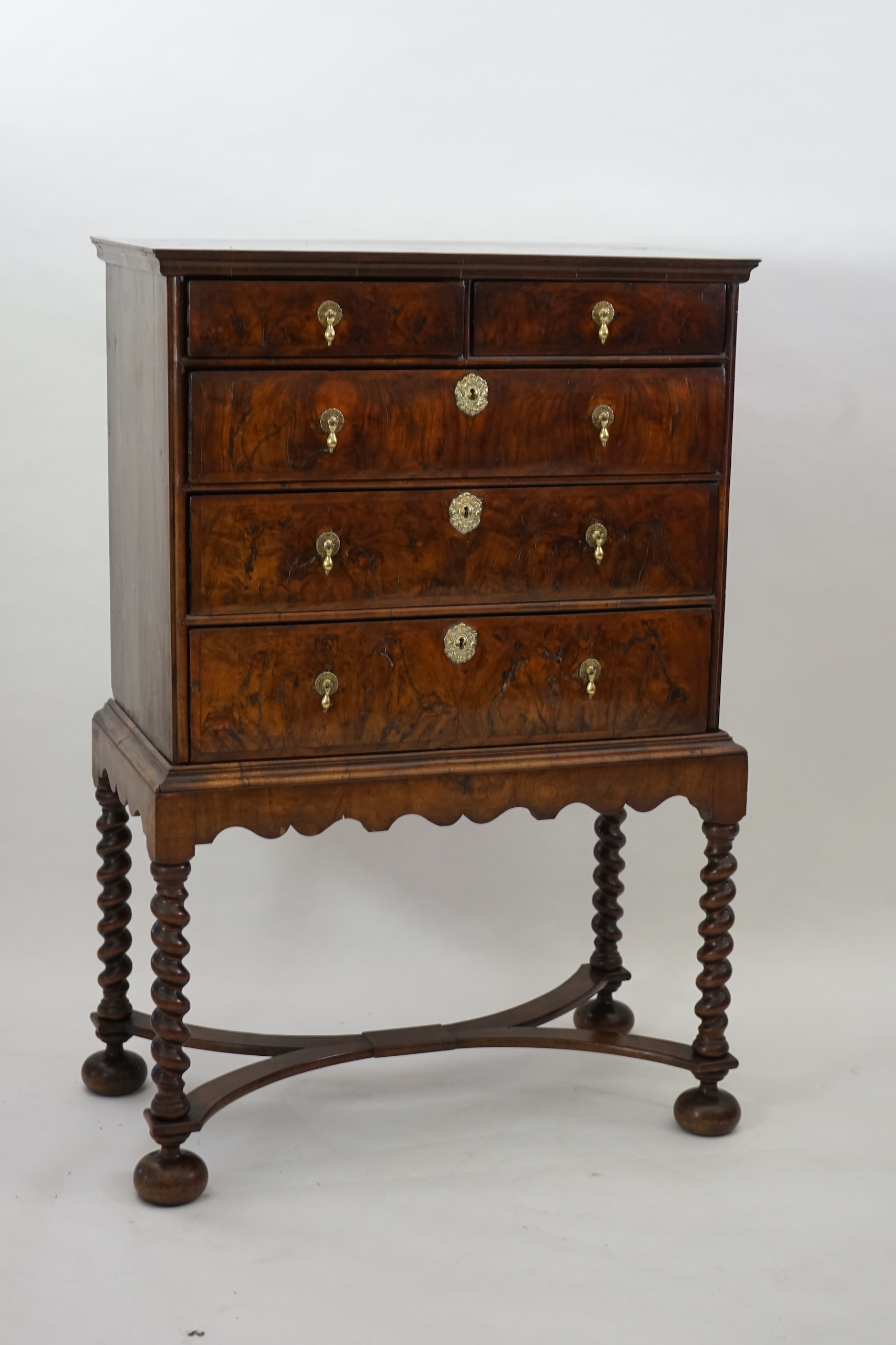 An early 18th century and later crossbanded walnut chest on stand